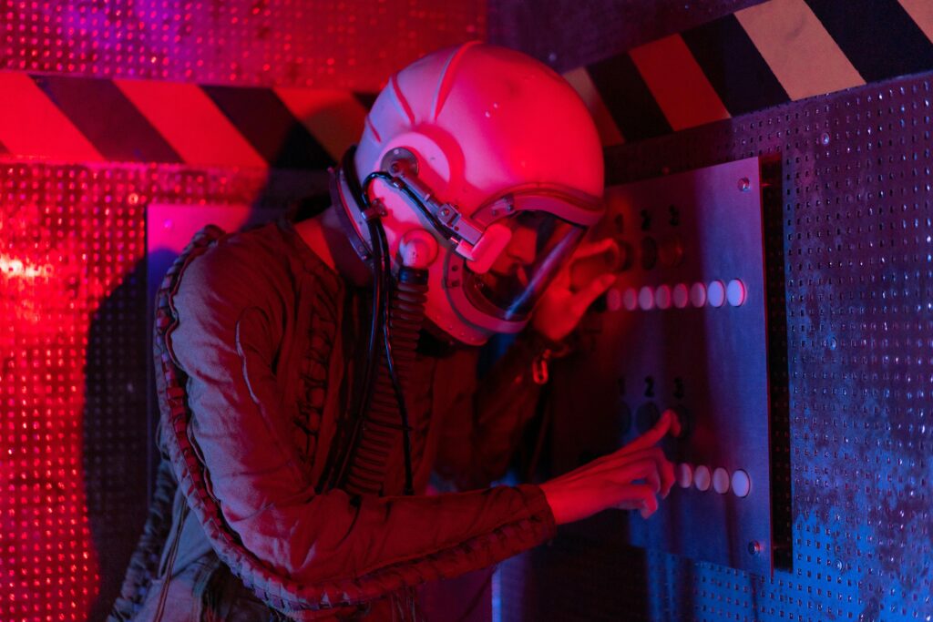 Female astronaut interacts with a control panel in a futuristic spaceship setting.